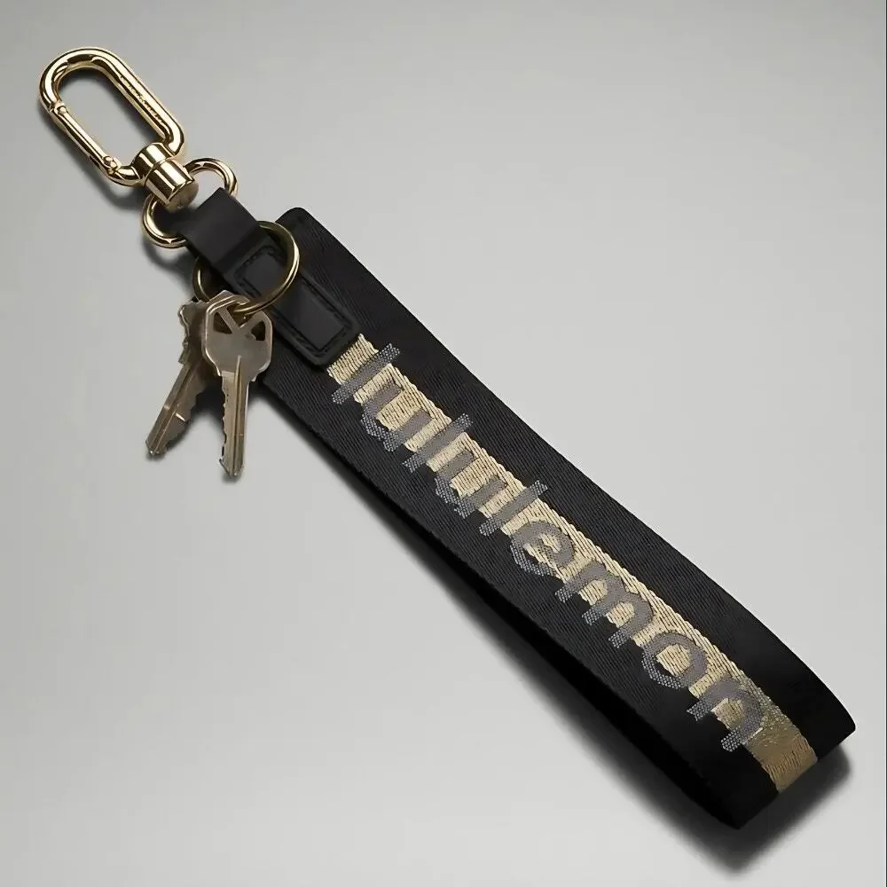NEW Lululemon Never lost Keychain Wordmark Black and Gold