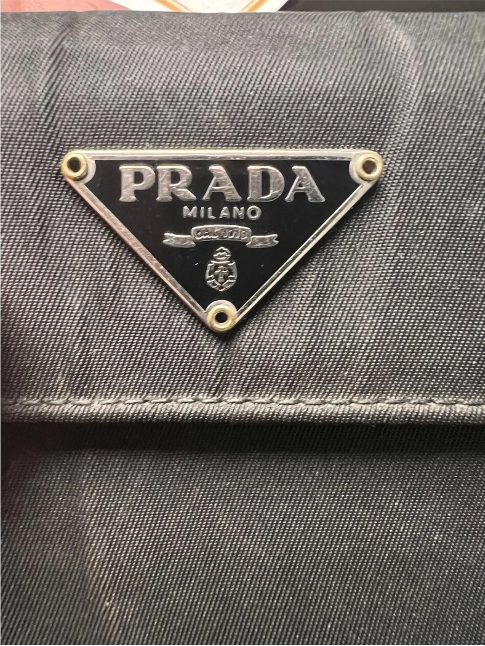 Prada wallet prominent