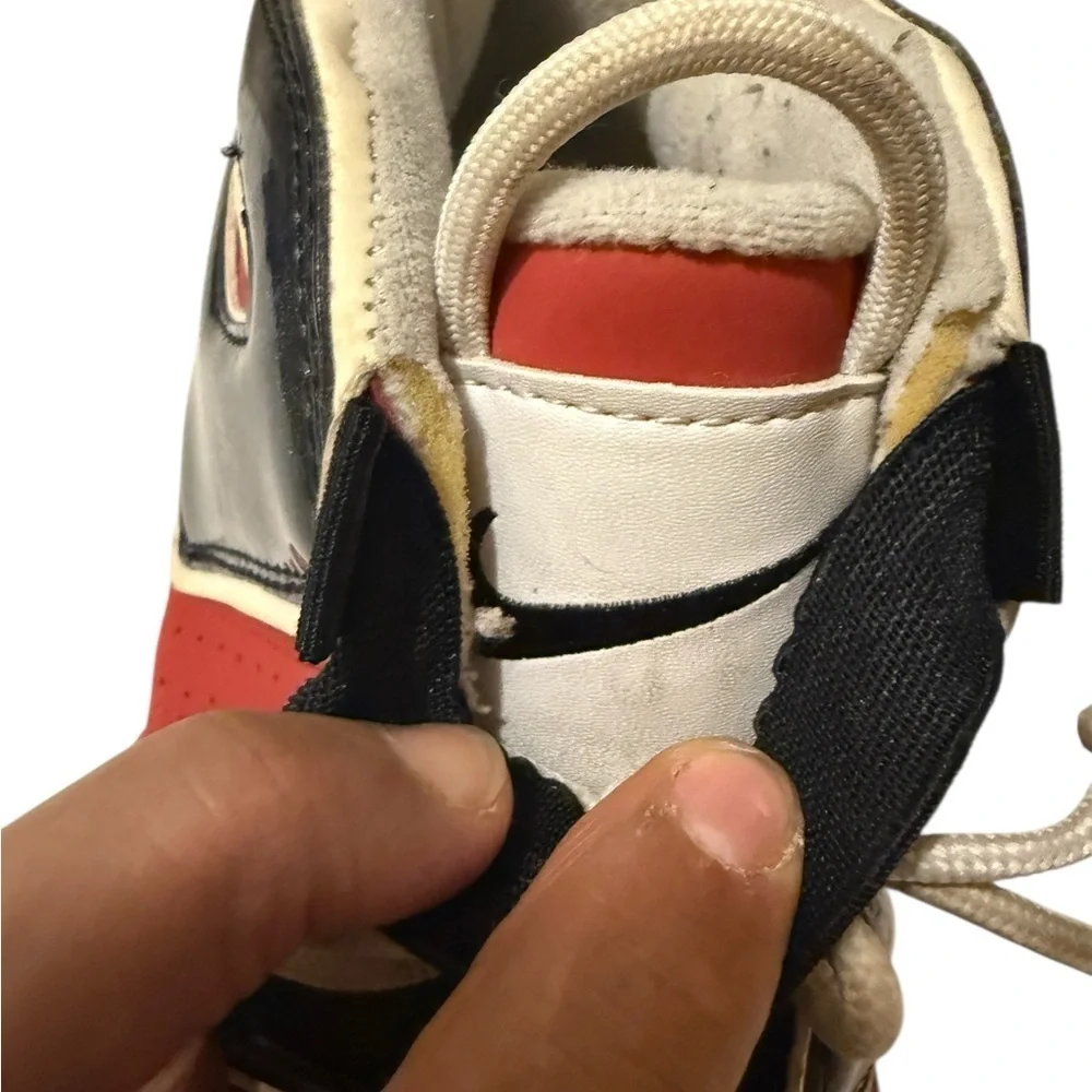 This is a pair of Nike Air More Uptempo '96 basketball shoes in a red, black.