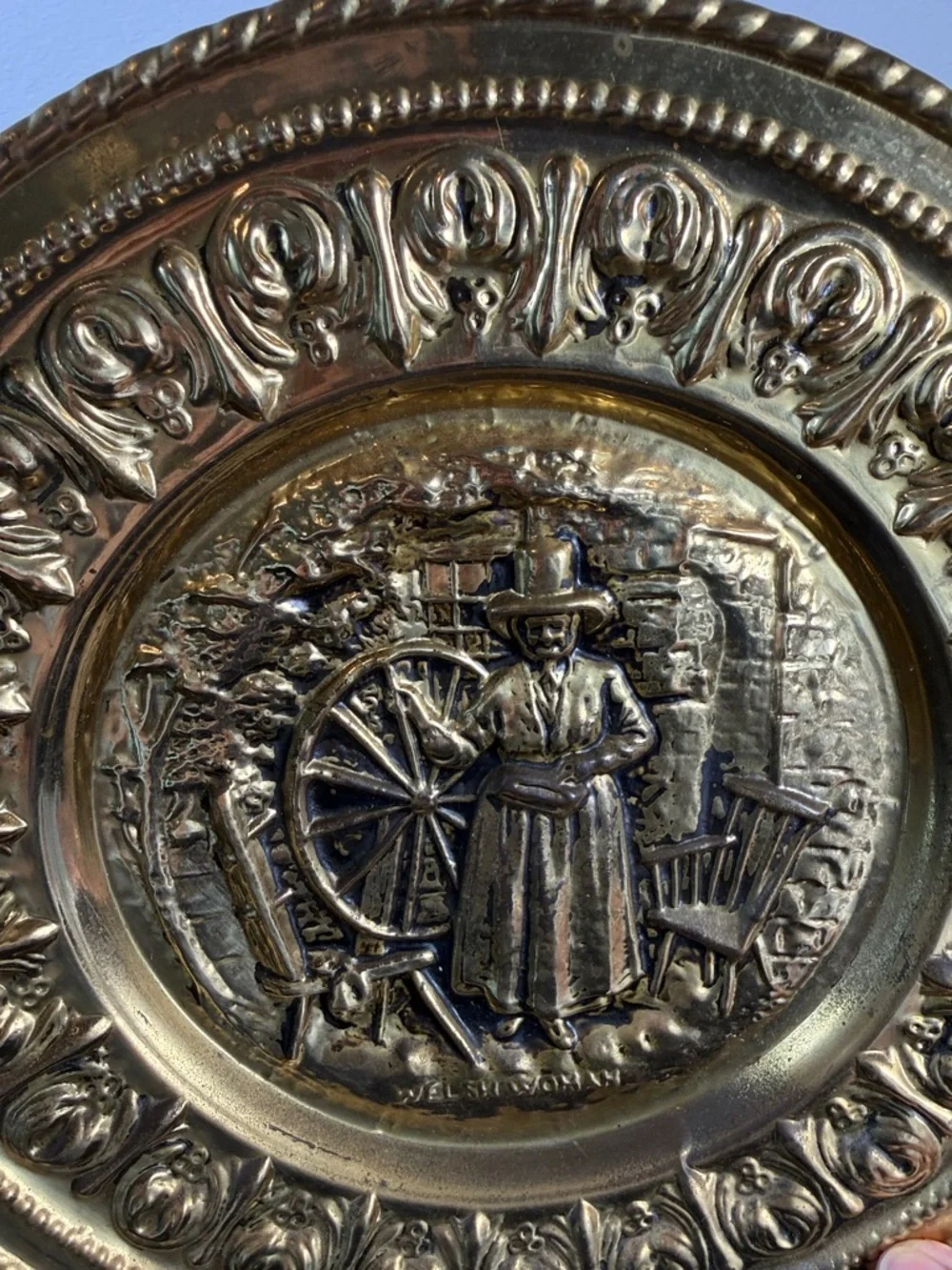 Decorative Embossed Brass Wall Plate with Spinning Wheel Motif