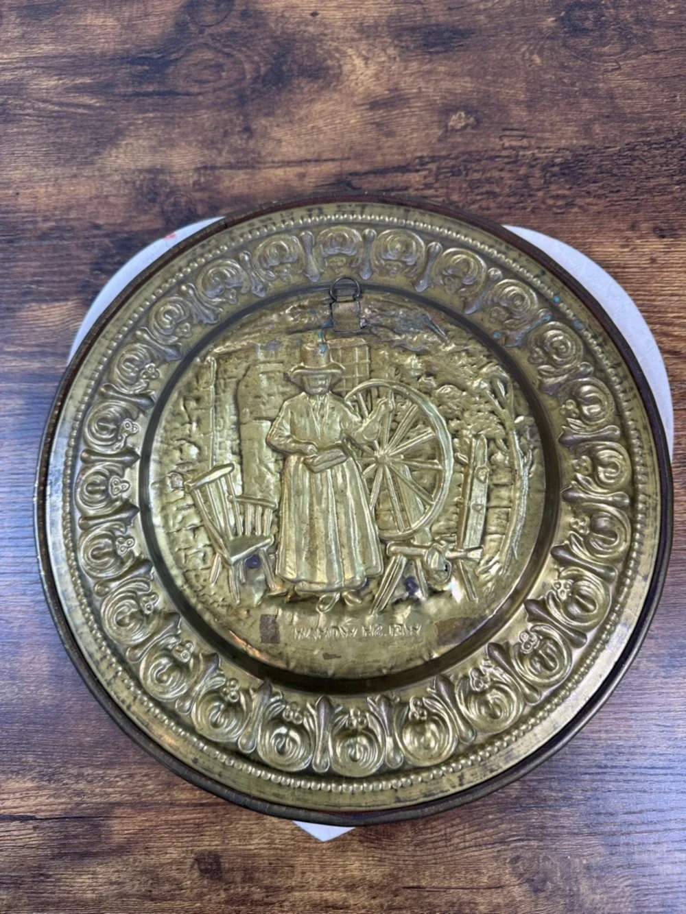 Decorative Embossed Brass Wall Plate with Spinning Wheel Motif