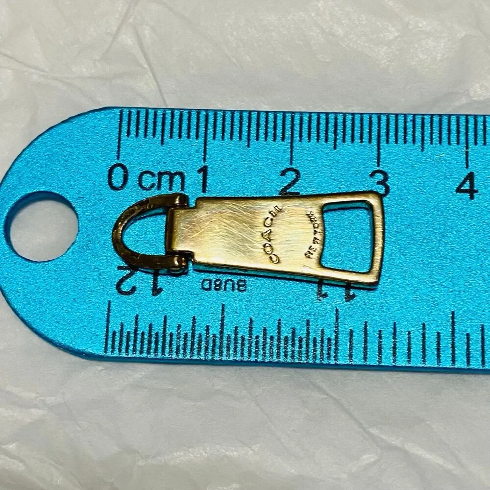 Coach zipper pull