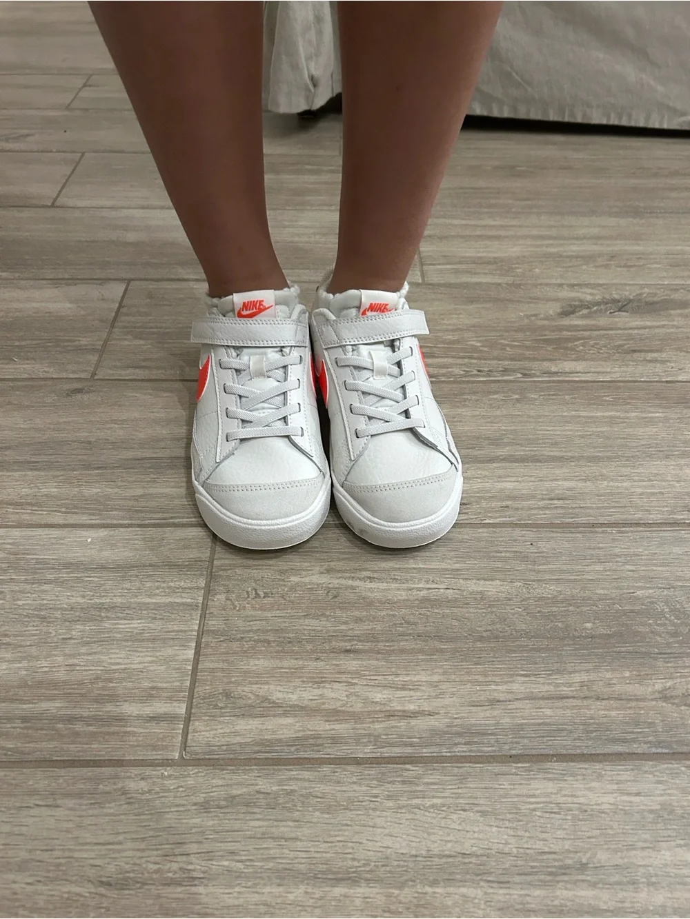 Nike Women’s White Sneakers with Coral Swoosh Accent