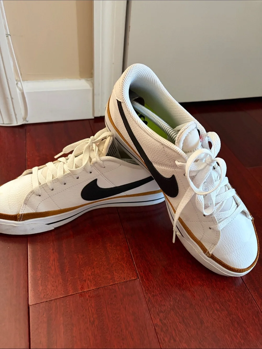 Nike WoMen’s White Sneakers with Black Swoosh and Gold Trim