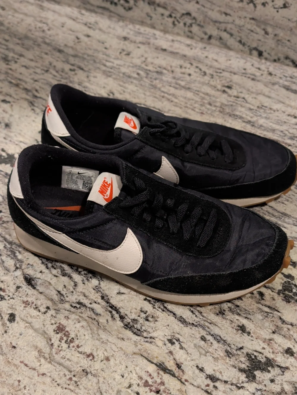Nike Black Sneakers with White Swoosh and Orange Tongue Logo