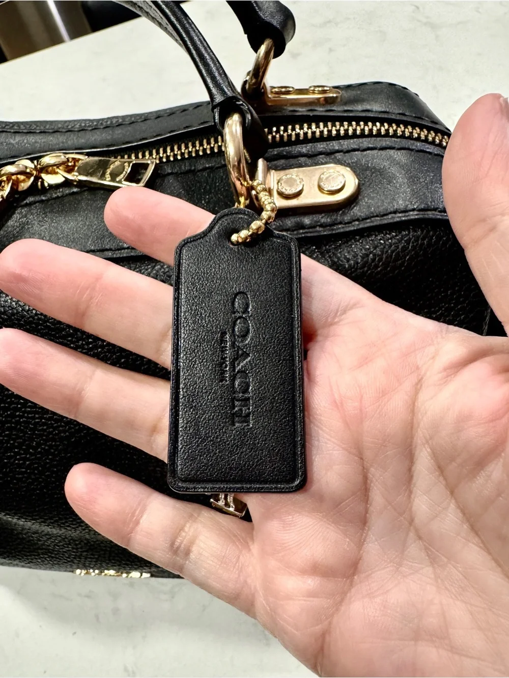 Coach polished pebble