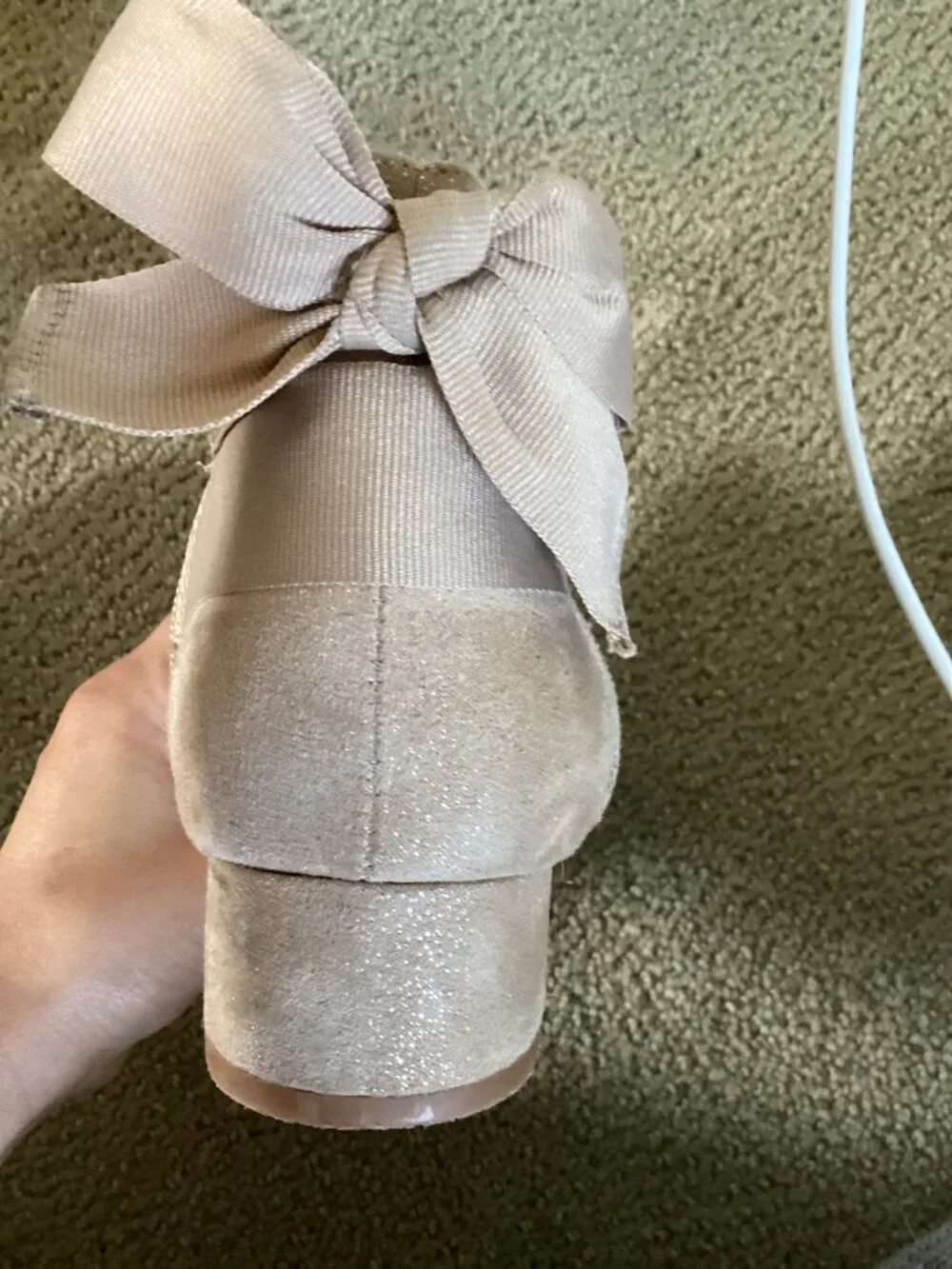 Heels for kids with bow on back of shoe.