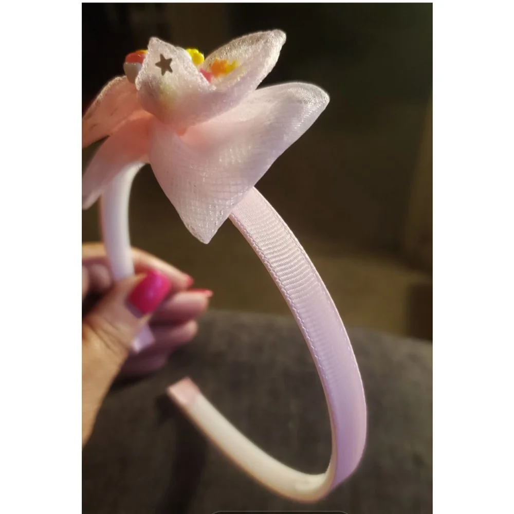 Four Hello Kitty headbands with small figurine