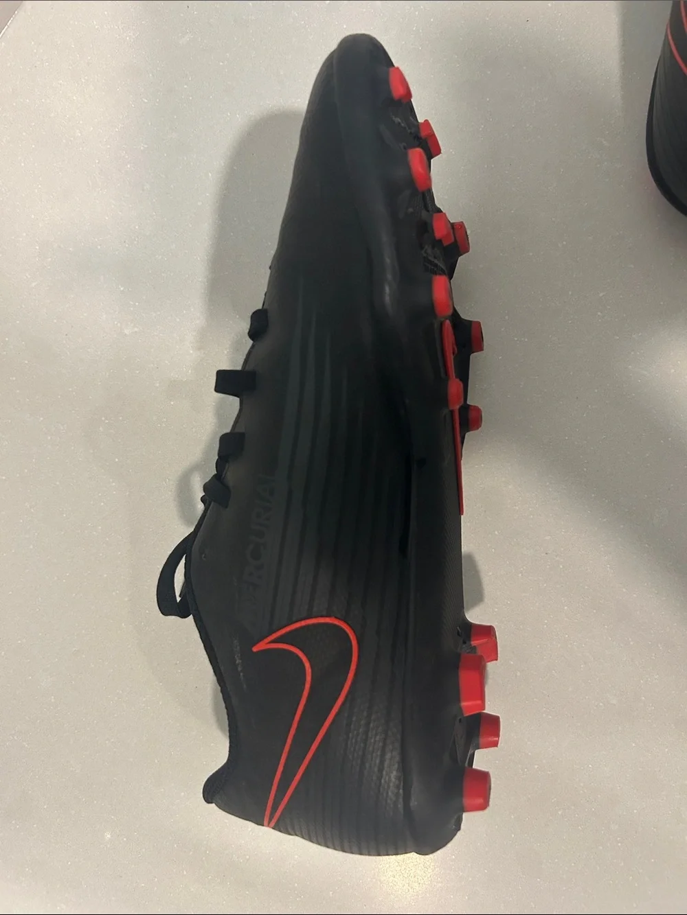 Kids Black Soccer Cleats with Red Accents
