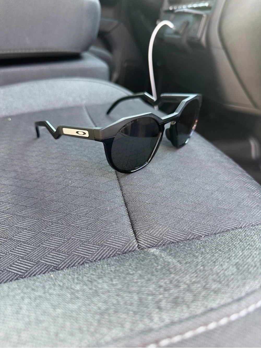 Oakley Men’s Black Round Frame Sunglasses with Silver Logo Accent