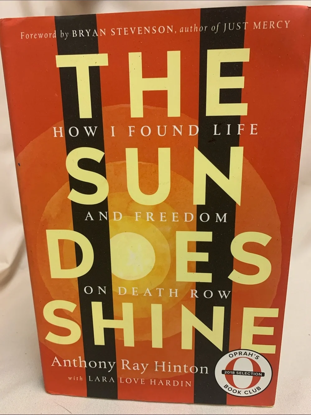 The Sun Does Shine by Anthony Ray Hinton — Orange Hardcover Book