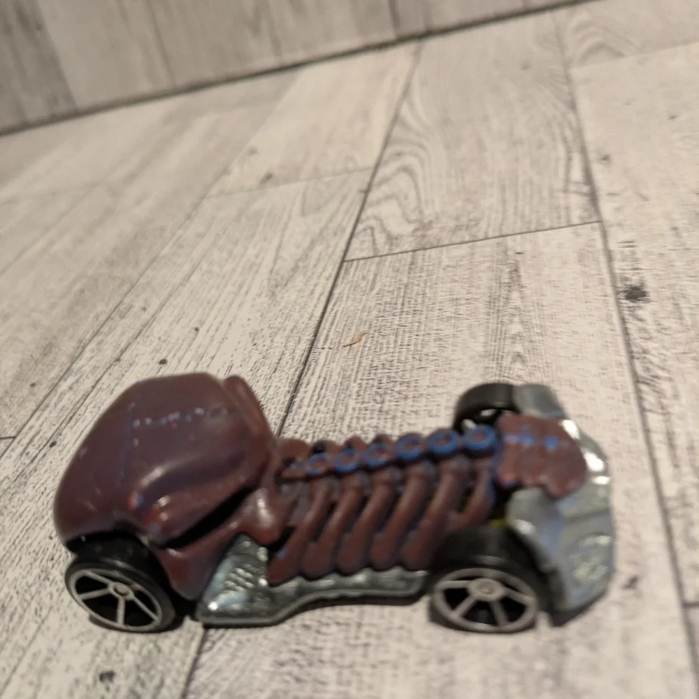 hot Wheels Bone Racer Toy Car with Brown and Silver Accents