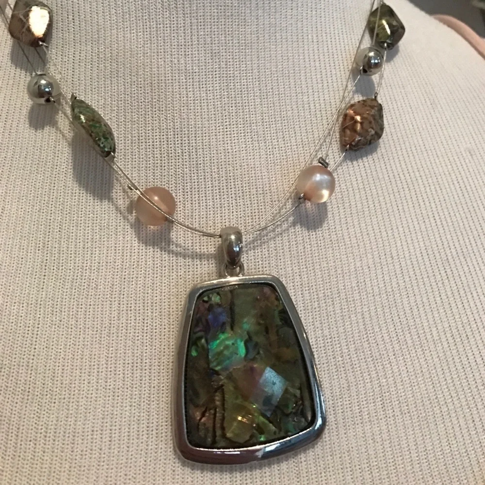 Faceted colorful pendant on triple wire with beads